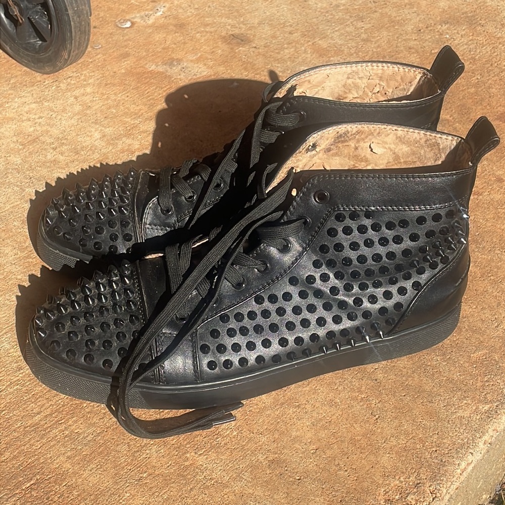 Black studded Christian Louboutin red bottoms